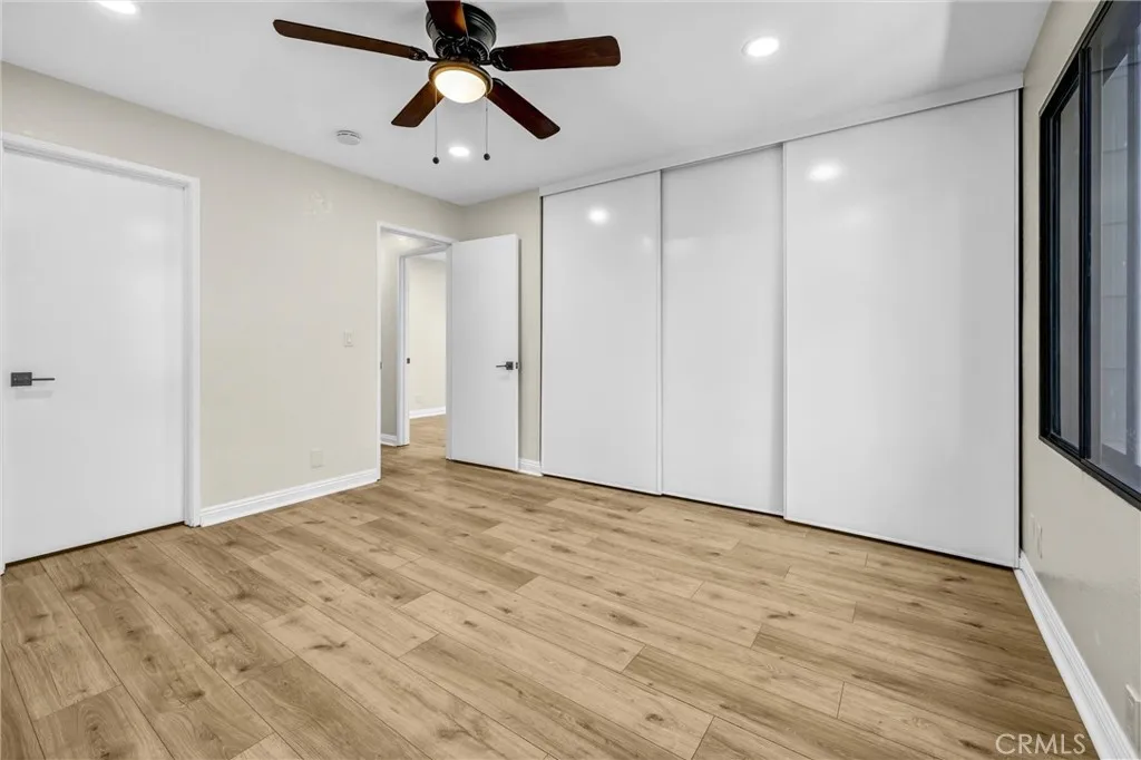 View of bedroom two towards the bathroom door and hallway.
