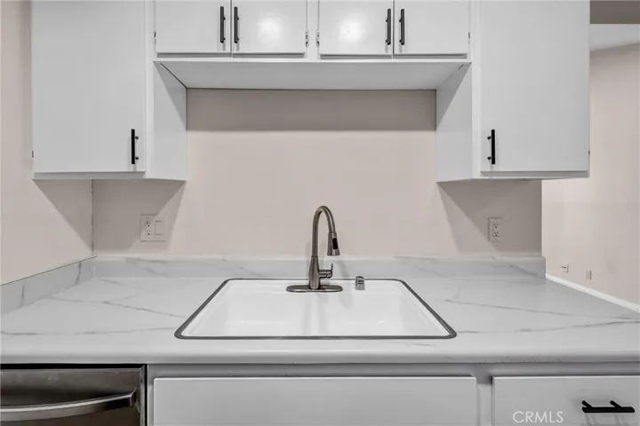 The cabinets have been painted and feature new hardware.