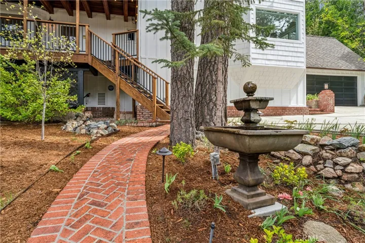 Brick (with cement base) walkway to handcrafted timber pavilion.