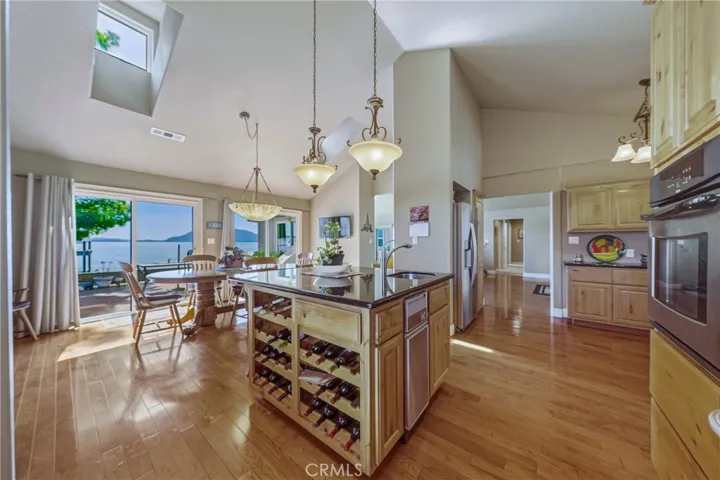 Island with wine storage , bar sink, beverage refigerator, and Trash compactor.
