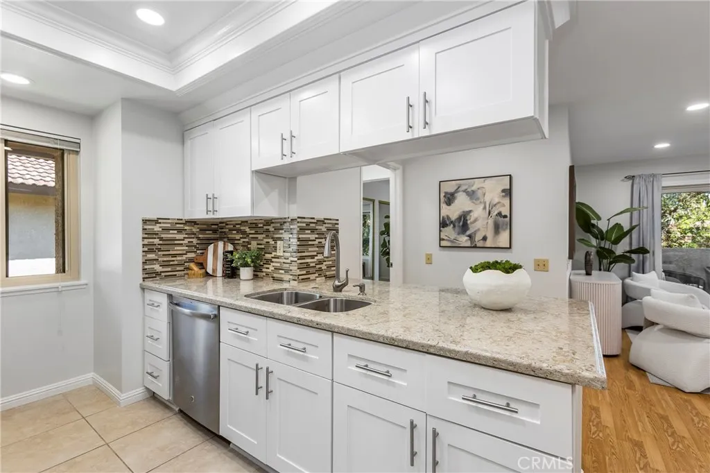Updated Kitchen with White Shaker Cabinets, Quartz Counters, Stainless Appliances, 5 Burner Stove w/Griddle, Tray Ceilings with Recessed Lighting and Crown Molding