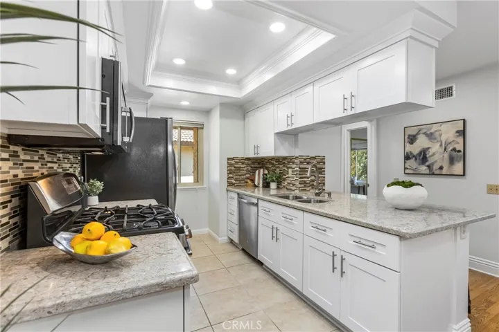 Updated Kitchen with White Shaker Cabinets, Quartz Counters, Stainless Appliances, 5 Burner Stove w/Griddle, Tray Ceilings with Recessed Lighting and Crown Molding