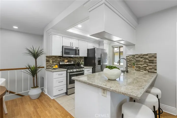 Open Concept KItchen Updated Kitchen - with White Shaker Cabinets, Quartz Counters, Stainless Appliances, 5 Burner Stove w/Griddle, Tray Ceilings with Recessed Lighting and Crown Molding