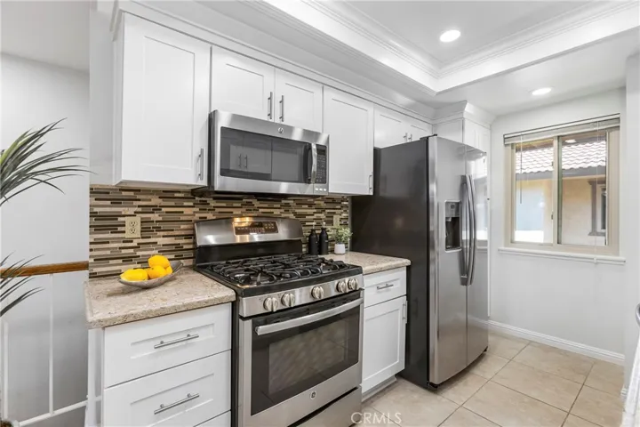 Updated Kitchen with White Shaker Cabinets, Quartz Counters, Stainless Appliances, 5 Burner Stove w/Griddle, Tray Ceilings with Recessed Lighting and Crown Molding