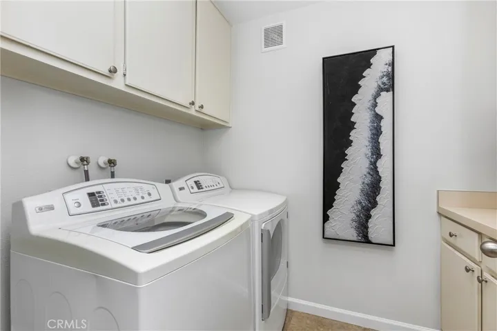 Inside Laundry Room with PLenty of Storage Cabinets and Skylight
