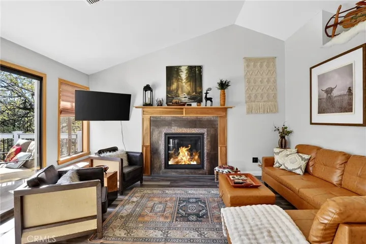 Main living area with access to deck and gas fireplace