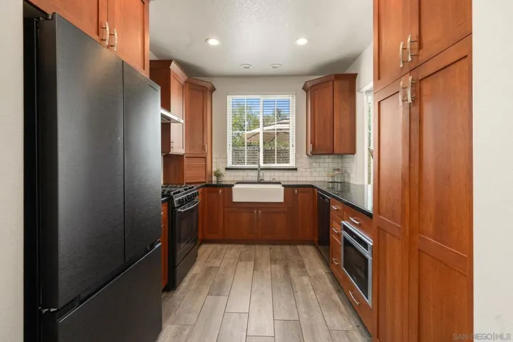 Prep space anchored by a brand-new refrigerator and streamlined cabinetry storage designed for the home chef.
