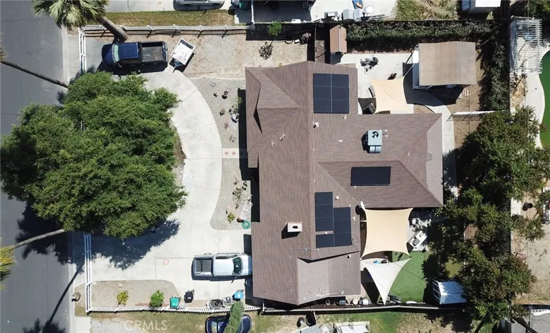 drone view showing circular driveway and RV parking at the top of the photo