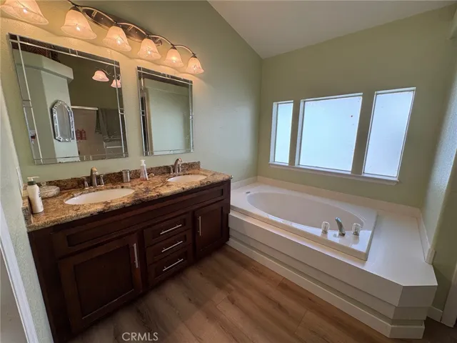 Primary en suite bathroom offers an Oval tub and separate shower plus a separate small room for the commode. Granite counters and shaker cabinets, everything is higher end. Even the windows are a great layout.