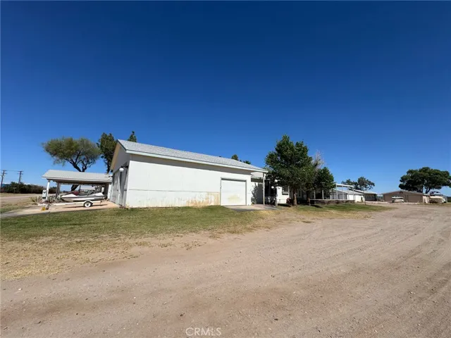 HUGE GARAGE and very tall doors for your pontoon boat or motorhome possibly. Side exit too.