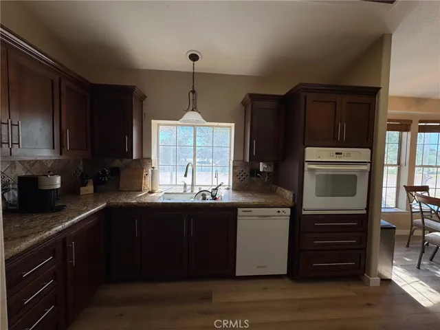 L-Shape kitchen counters are across from the cooktop and refrigerator wall. More water views here at the sink.