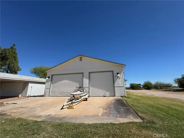 Long driveway and tall roll up garage doors for tall boats.