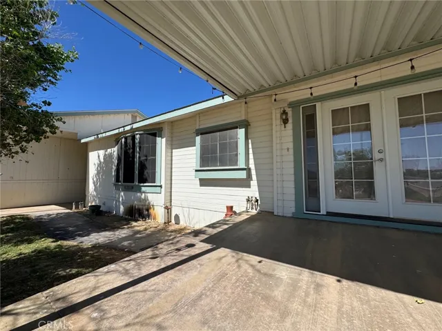 Two steps down to the walk way to the garage. Even a planter to plant your favorite plants which is not offered on most properties. The windows on the left are the kitchen Sink window and a breakfast nook with great lagoon views!