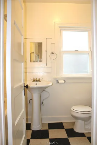 Bathroom, adjacent to bedroom & laundry area
