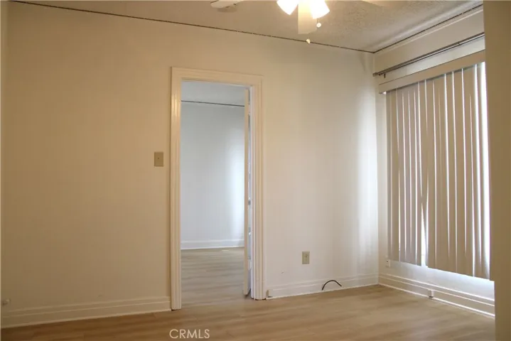 Bedroom with ceiling fan & large picture window