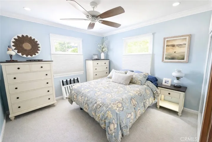 Guest bedroom with ceiling fan and recessed lighting