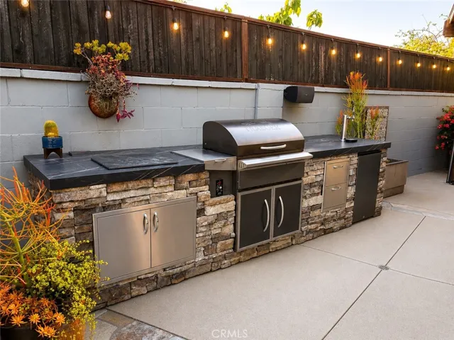 Custom slab with Trager BBQ and refrigerator