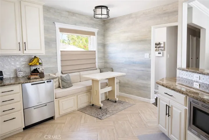 Kitchen with built-in window seat with cushion