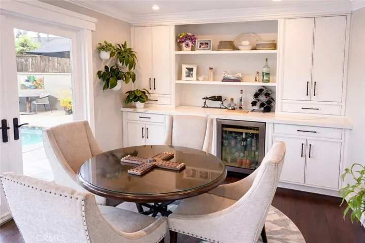 Dining area with custom built-in storage and beverage refrigerator included