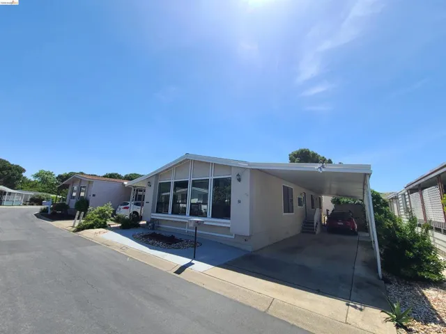 Tandem parking on right side of mobile home with access through utility room.