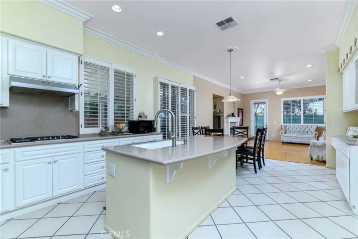 island counter/sink....easily slide up 3-4 counter stools....quick bites!!!......and the attached den/family room....