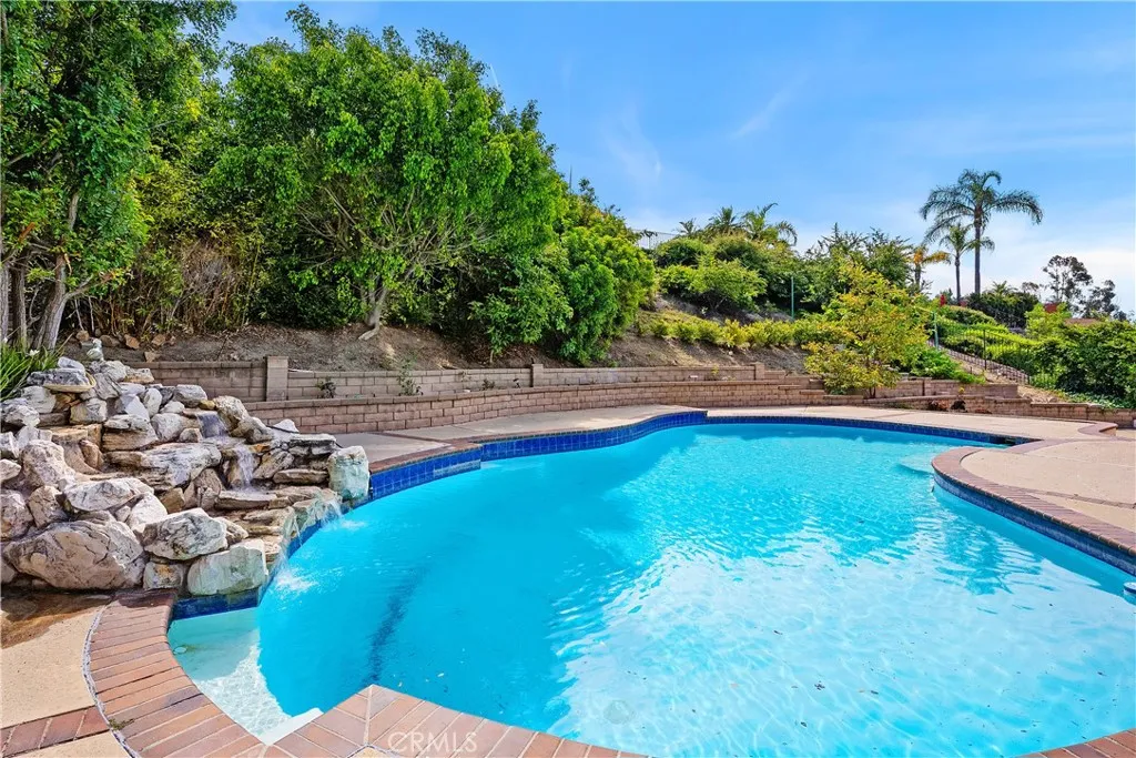 In ground diving pool with rock waterfall.