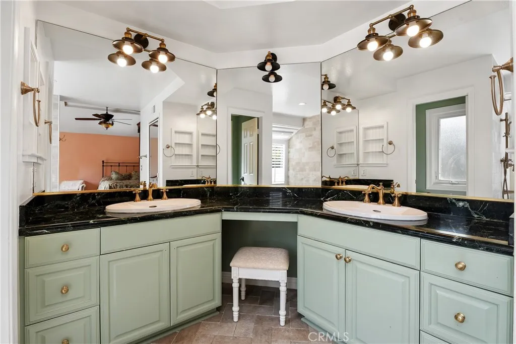 Primary suite bathroom. Vanity area, double sinks, and water closet.