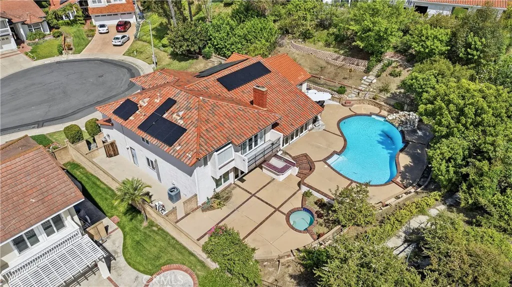 Aerial view of in-ground pool and spa. Mature fruit trees and garden paths. Dual side yards. Cars and personal objects digitally removed. original photos https://bit.ly/3OvKmPn