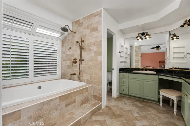 Built in soaking tub, double shower head, and water closet.
