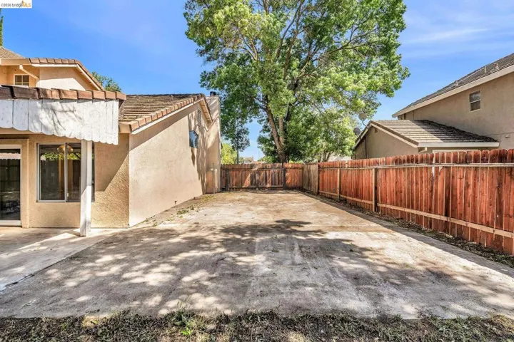 Fenced backyard with a patio