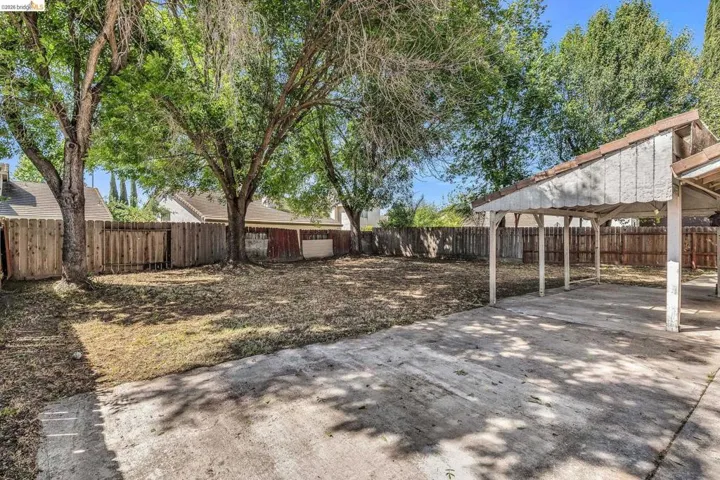 Fenced backyard with a patio