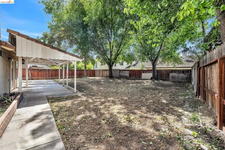 Fenced backyard with a patio area and a pergola