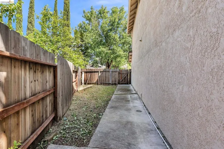 Fenced backyard featuring a gate
