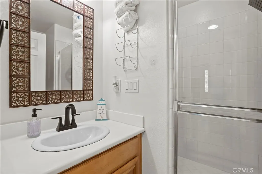 Convenient downstairs bathroom with a single-sink vanity and walk-in shower