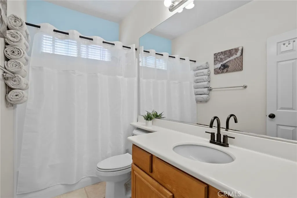 Full bathroom with a large vanity and shower/tub combination