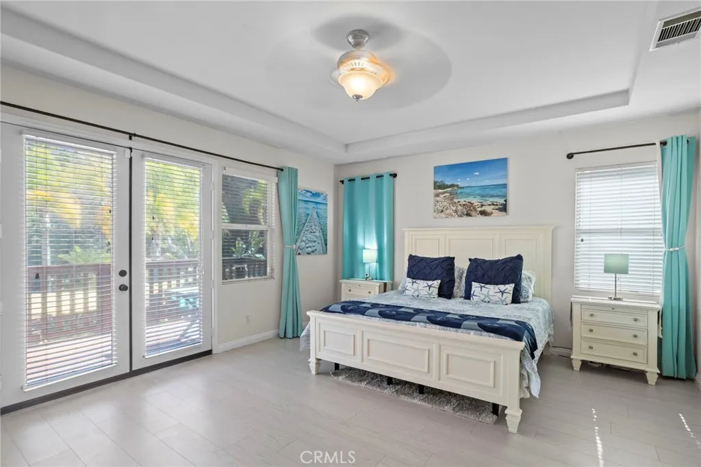 Spacious primary bedroom with private balcony access