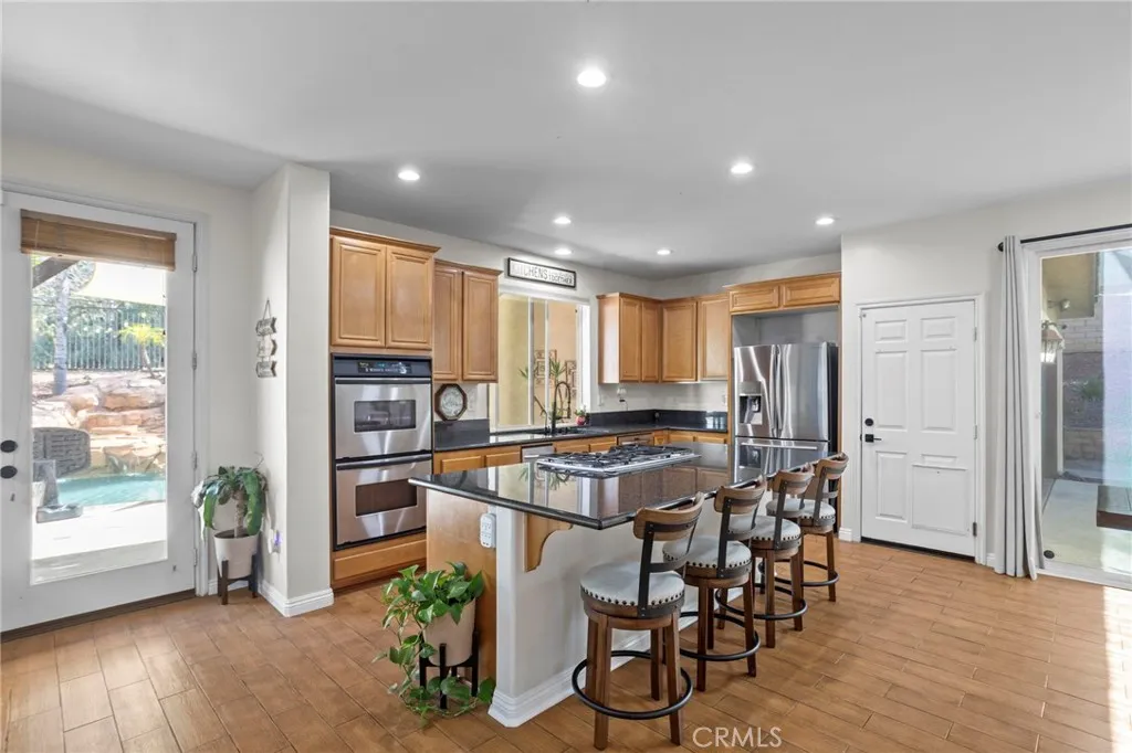 Kitchen with center island, seating, and seamless flow to the outdoor area