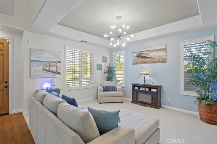 Living room with multiple windows, natural light, and a spacious layout