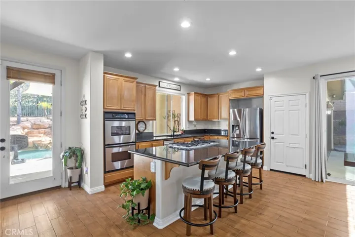 Kitchen with center island, seating, and seamless flow to the outdoor area