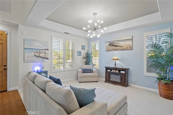 Living room with multiple windows, natural light, and a spacious layout
