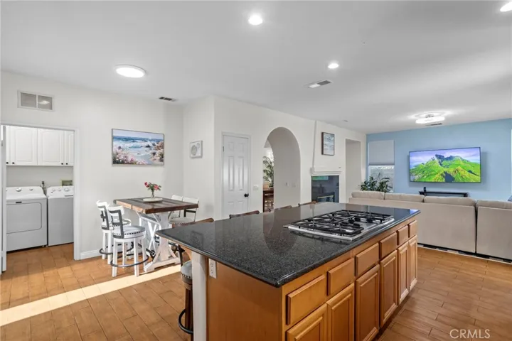 Kitchen with adjacent dining area, offering an open and connected layout