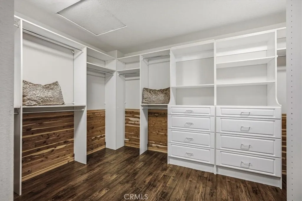 Custom Primary en Suite closet with ample drawers and Cedar wood.