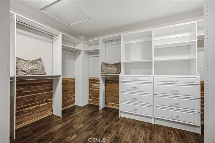 Custom Primary en Suite closet with ample drawers and Cedar wood.