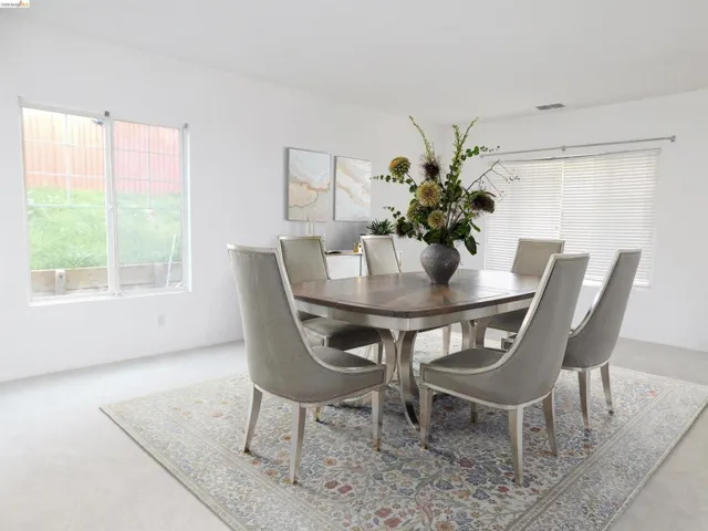 Dining room with light colored carpet