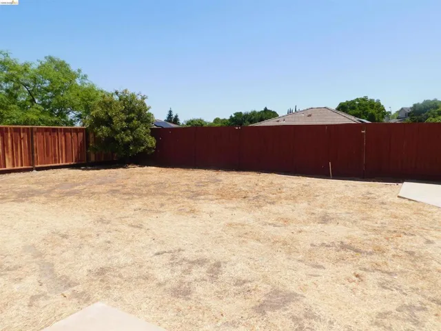 View of fenced backyard