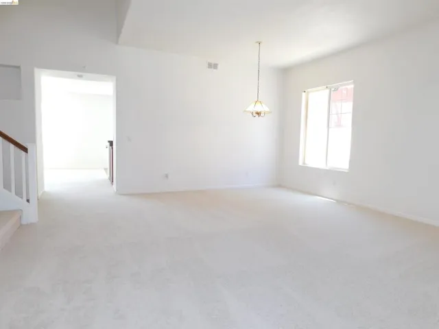 Spare room featuring light carpet