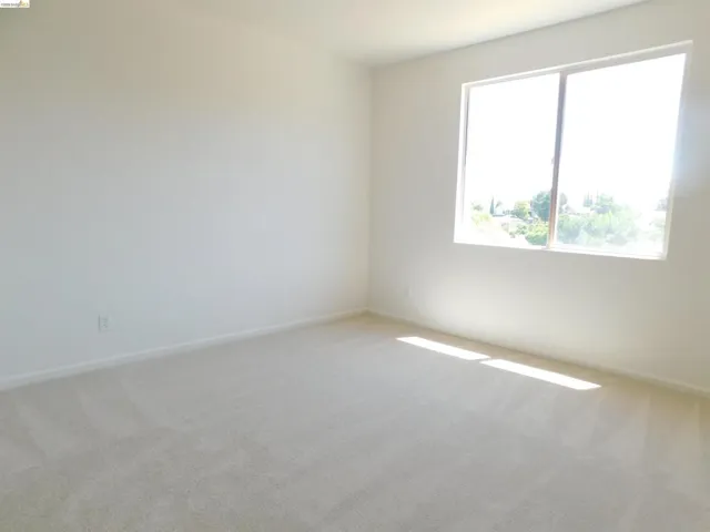 Unfurnished room with light colored carpet