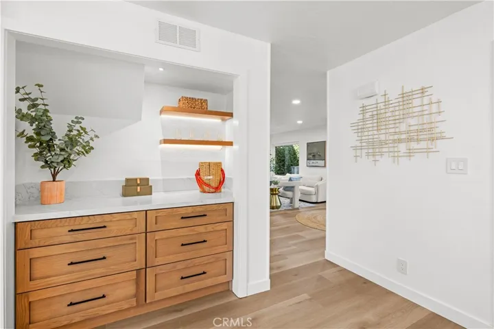 Hallway storage area featuring custom cabinetry and shelving with a clean, modern look.