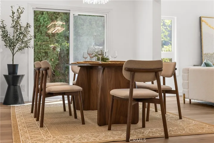 Dining area with large windows, offering natural light and a comfortable setting.