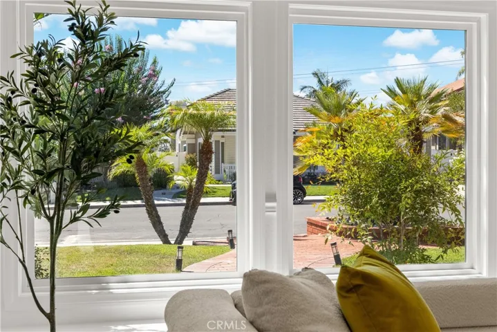 Living Room View to Front Yard – Highlighting the spacious, bright room with a beautiful view of the well-manicured front yard and street.